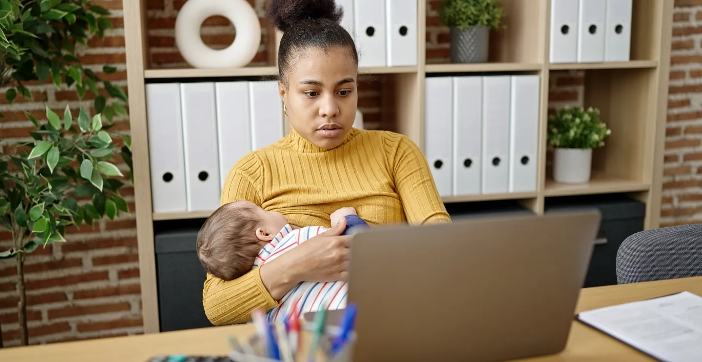 Woman breastfeeding while working